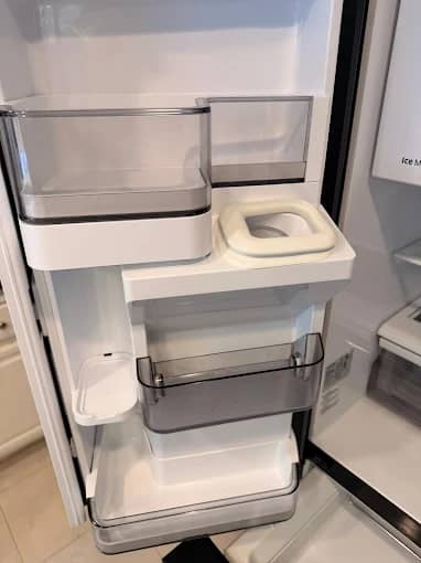 Refrigerator bins removed and washed during a deep cleaning