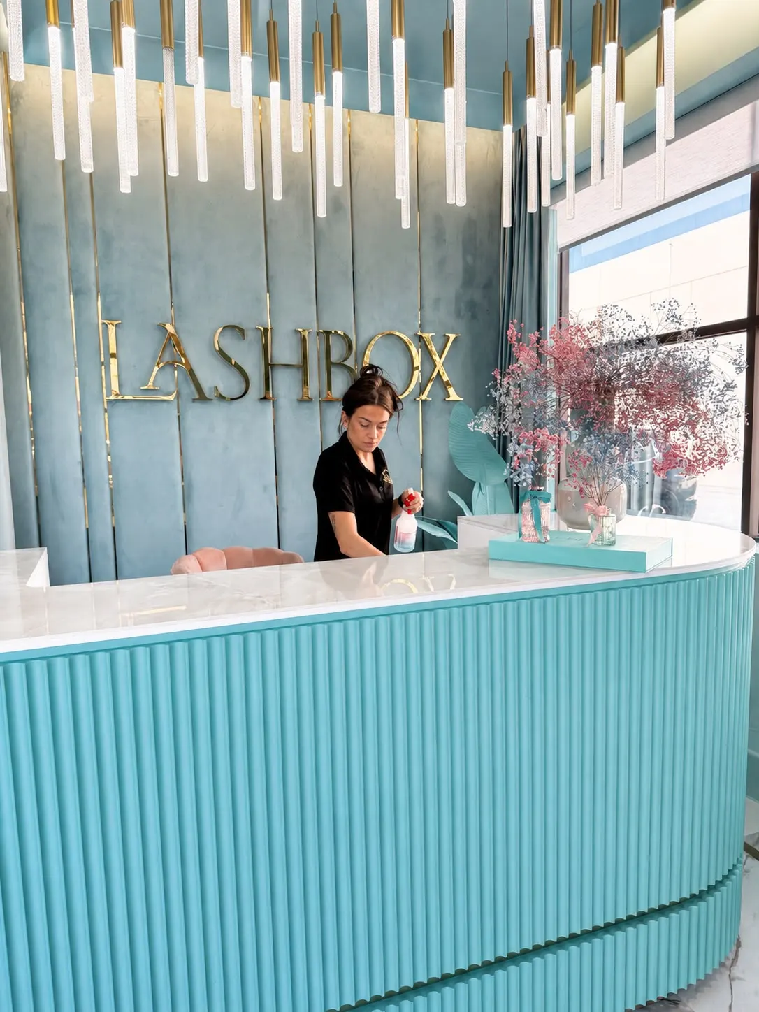 Gabby's Cleaning detailing the marble reception desk of a luxury lash studio in Orange County