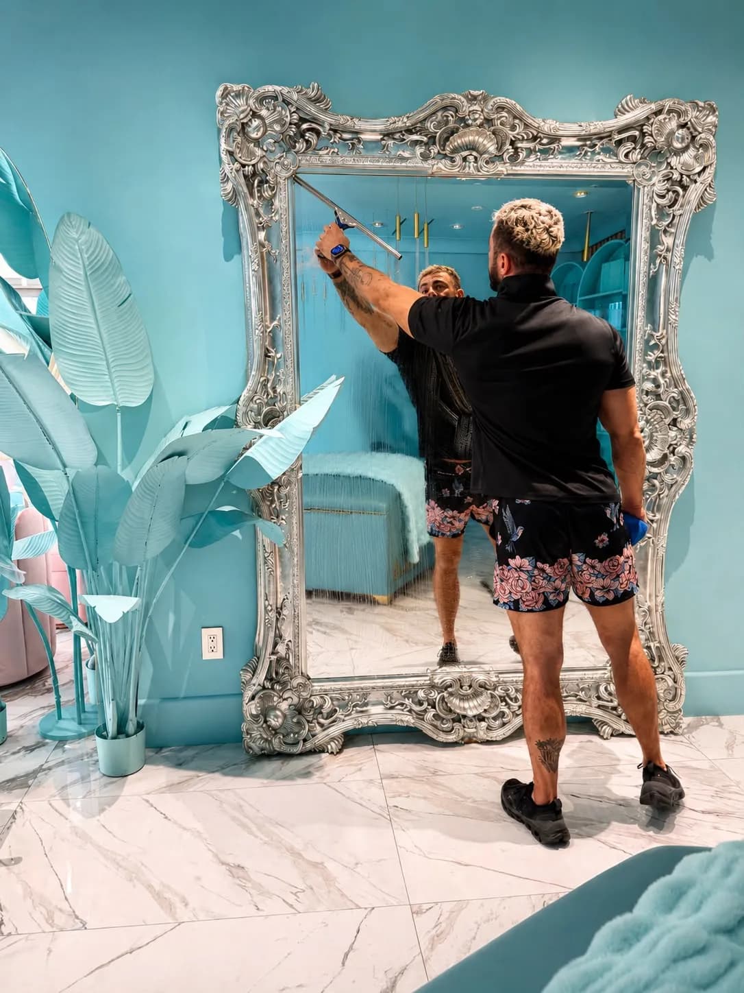 Paul squeegeeing an ornate silver-framed mirror at an Orange County beauty studio