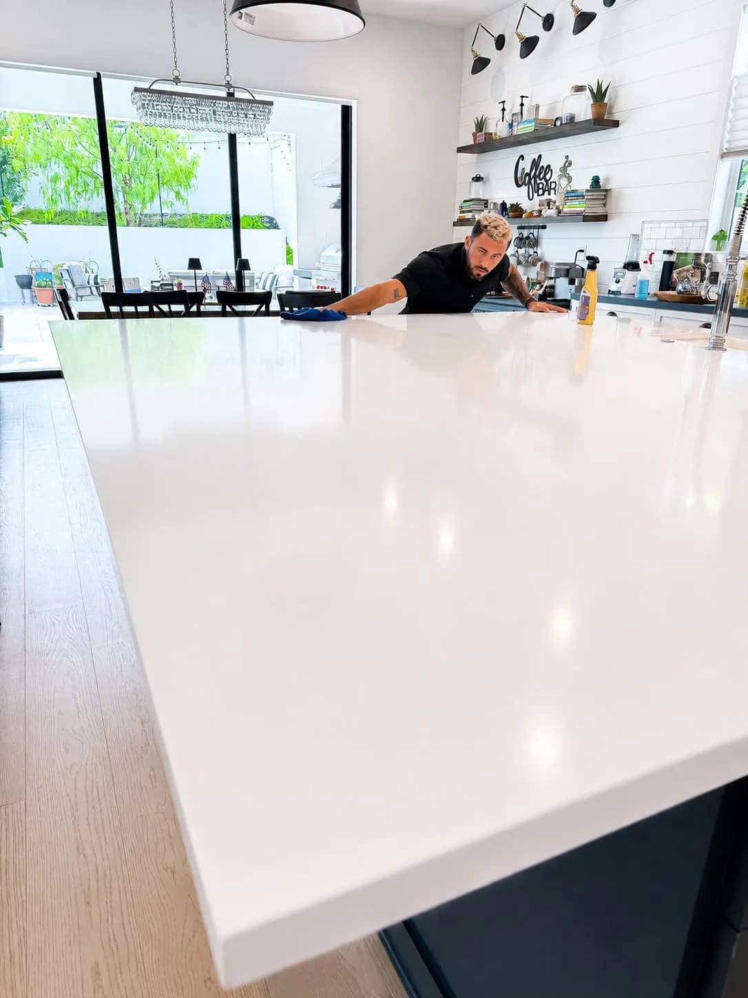 Paul polishing a white quartz kitchen island to a streak-free finish in Huntington Beach