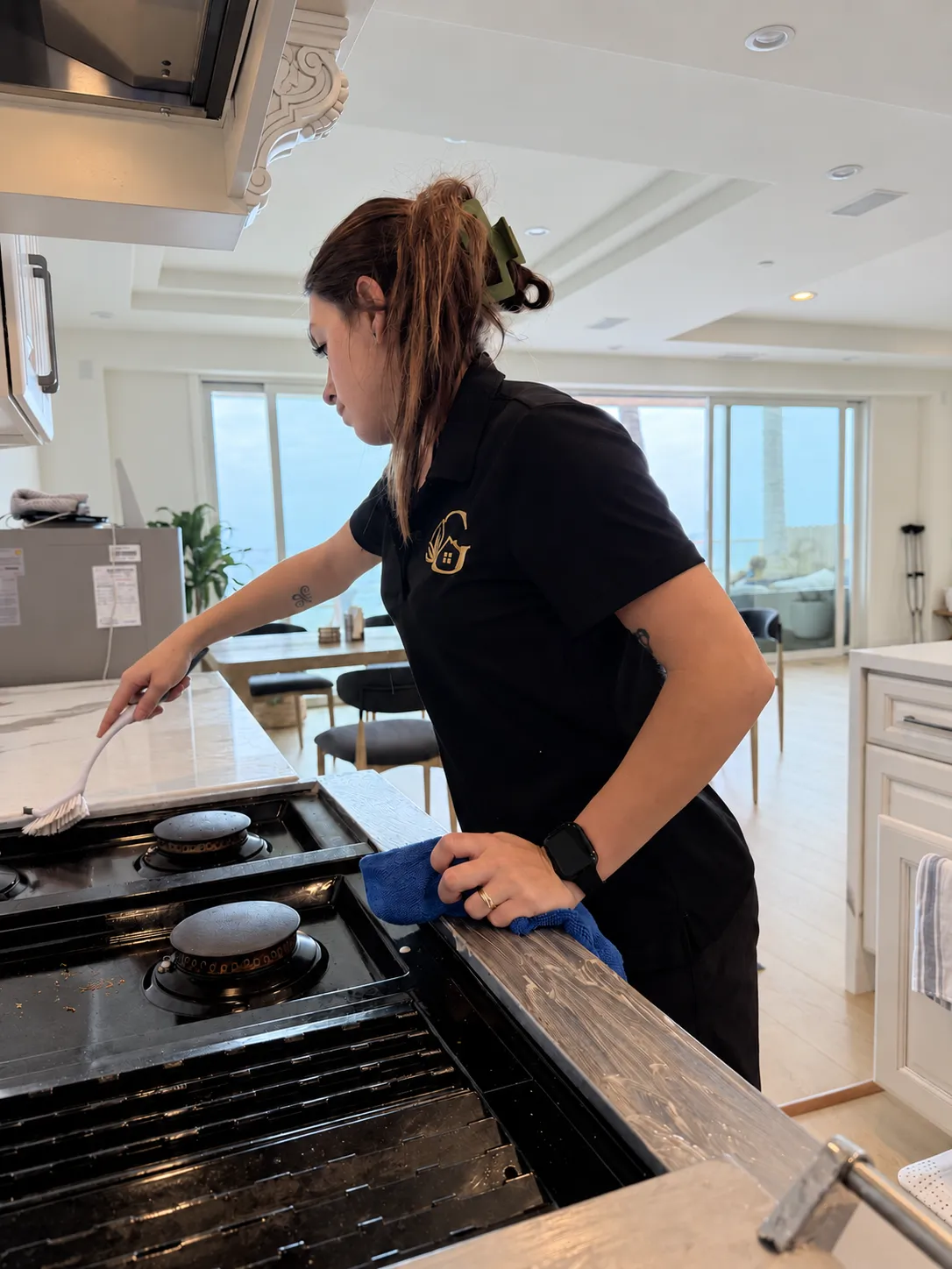 Gabby detailing a professional gas range in an oceanfront Dana Point kitchen