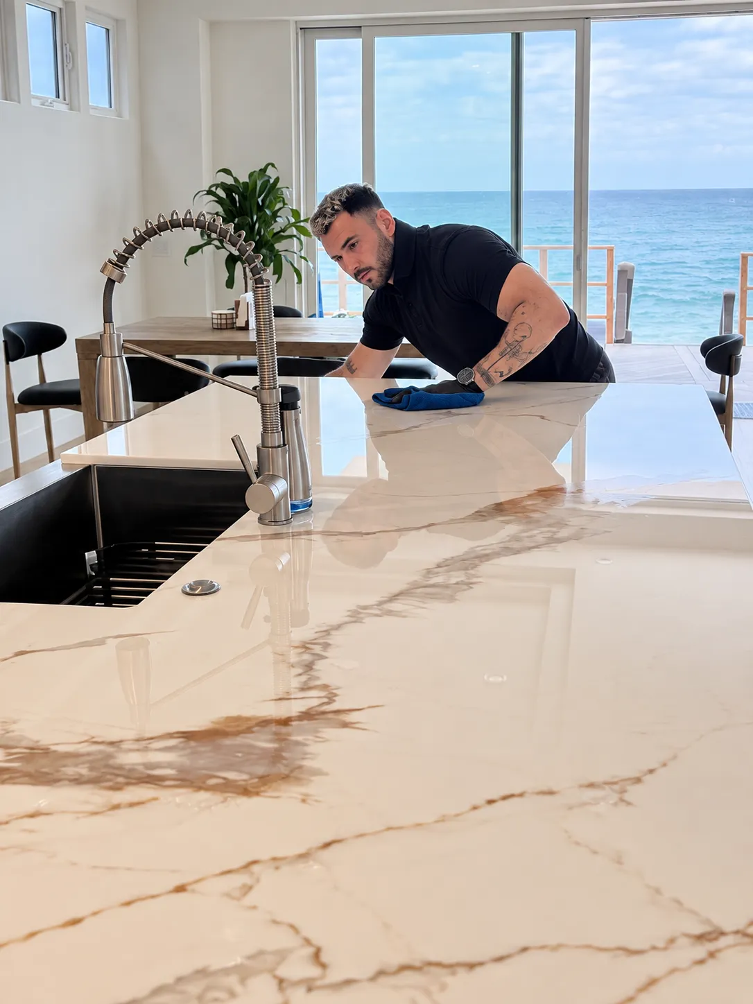 Paul polishing a marble kitchen island to a mirror finish in an oceanfront Dana Point home