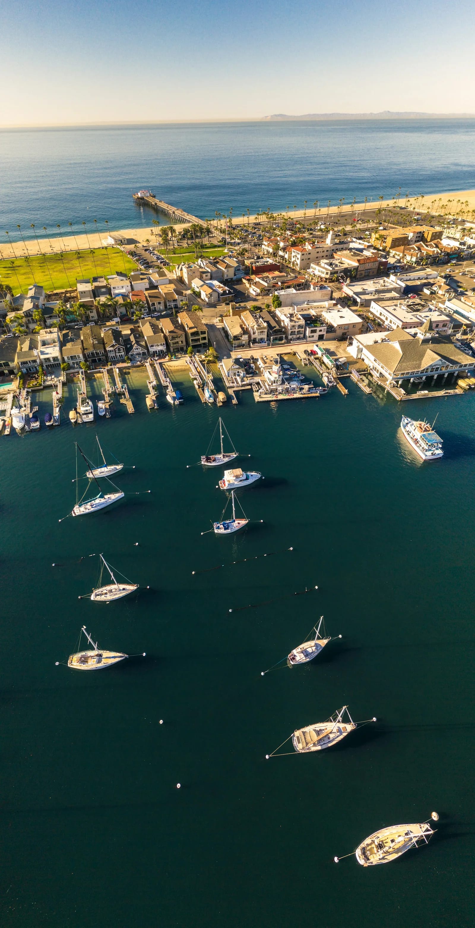 Aerial photograph of waterfront buildings, docks, and boats in Newport Beach