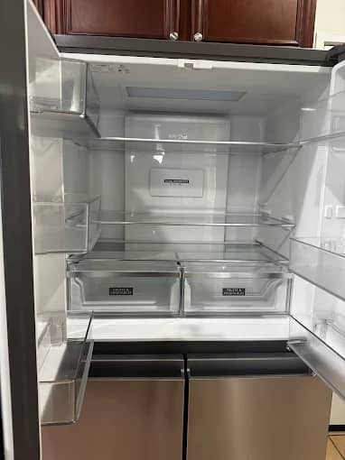 Empty refrigerator cleaned inside-out for a move-out walkthrough